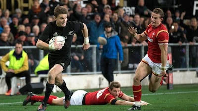 New Zealand's Beauden Barrett runs in for his second try against Wales during the third and final Test on Saturday at Dunedin. Brett Phibbs / AP Photo