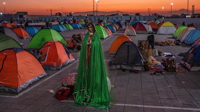 Pilgrims sleep next to images of the Virgin of Guadalupe outside a basilica in Mexico City. AFP