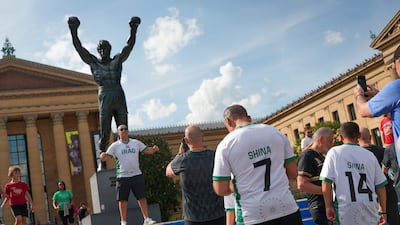 Iraq fans take a picture with the Rocky statue. Joshua Longmore / The National