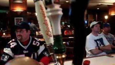 Kevin Nordberg, left, discusses the presidential campaign while watching an American football game at Joe Theismann's Restaurant in Alexandria, Virginia.