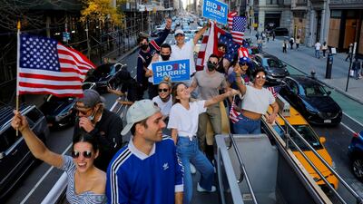 A group of friends who live in New York City celebrate after former Vice President Joe Biden was declared the winner of the 2020 U.S. presidential election as they ride down Fifth Avenue in a rented open top double decker bus in Manhattan, New York City, U.S. Reuters