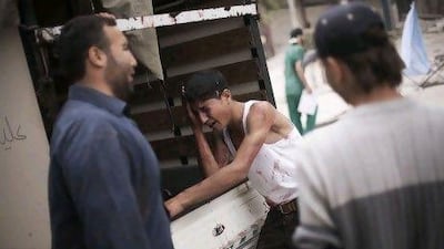 A Syrian youth cries next to a truck holding the body of his brother, killed by Syrian Army shelling, outside Dar Al Shifa hospital in Aleppo. Members of staff at the rebels’ field hospital say about 80 per cent of the 100 or so people treated daily are civilians.