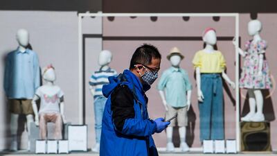 A man wearing a protective face mask looks on his cell phone in Stockholm, Sweden, on April 2, 2020. AFP