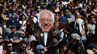 A supporter holds a cutout of Democratic presidential candidate Bernie Sanders during a rally in Brooklyn, New York on April 17, 2016. Presidential candidates are vying for the Big Apple's votes in the upcoming New York primary. Timothy Clary/AFP