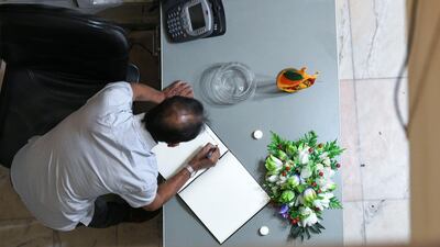 A man signs the condolence book.