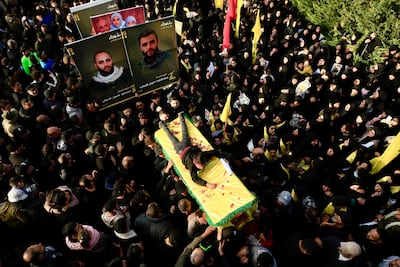 Mourners at the funeral of 22 Hezbollah fighters, killed during fighting with Israeli forces, in Baraashit, southern Lebanon, in December 2024. EPA