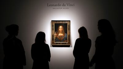 Viewers gather to view Leonardo da Vinci's Salvator Mundi, on display at Christie's auction rooms in London. The rare painting of Christ, which sold for a record $450 million, is heading to Louvre Abu Dhabi. Kirsty Wigglesworth / AP Photo