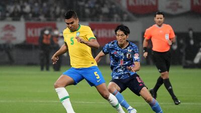 Brazil's Casemiro controls the ball under pressure from Japan's Genki Haraguchi during a friendly match in Tokyo on June 6, 2022. Getty