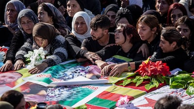 Women mourn during the funeral service. AP