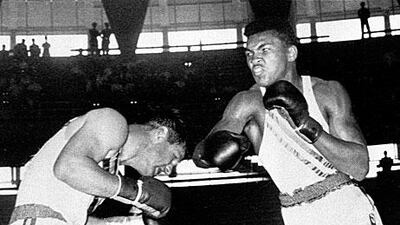 Cassius Clay, right, throws a right at Tony Madigan in the light-heavyweight semi-finals during the 1960 Olympic Games in Rome.