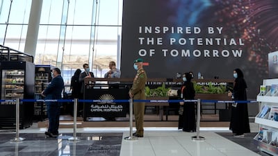 Exhbition visitors practice social distancing while lining up for coffee. Victor Besa / The National