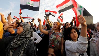 Women demonstrators hold Iraqi flags as they take part in a protest over corruption, lack of jobs, and poor services, in Baghdad, Iraq. Reuters