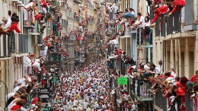 Revellers run with Torrestrella’s fighting bulls along the Calle Estafeta during the second day of the San Fermin Running Of The Bulls festival in Pamplona, Spain. Pablo Blazquez Dominguez / Getty