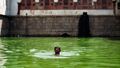 A man swims in the Hazrat Nizamuddin Baoli, the only one of Delhi's baoli's fed by springs.