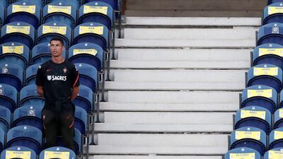 Portugal's Cristiano Ronaldo takes a seat on the stands without a mask. AP Photo