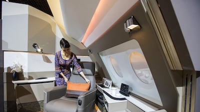 A flight attendant arranges a pillow on a leather seat in a mock-up Suite, designed by Pierrejean Design Studio, during the unveiling of the new cabins for the Singapore Airlines. Bloomberg
