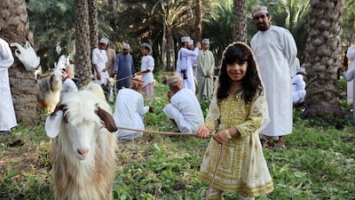 Omanis gather as goats are sold ahead of the Eid Al Fitr holiday, in the Surur area of Samail province, 80 kilometres south-west of the capital Muscat. AFP