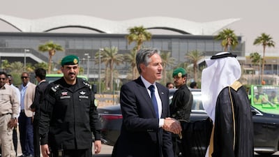 Mr Blinken shakes hands with a Saudi official before boarding a plane leaving Riyadh. AP