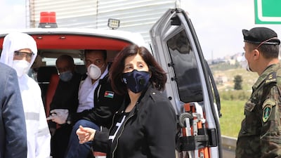 An ambulance transports two Palestinian patients who recovered from Covid-19, in the West Bank city of Nablus. EPA
