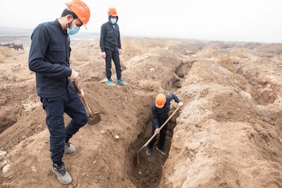The team digging up the mass grave. Thibault Lefébure for The National