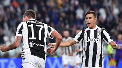 Mario Mandzukic and Paulo Dybala, right, in action during the 1-0 Serie A win over Fiorentina on Wednesday. Alessandro Di Marco / ANSA