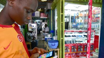 A man with his smartphone in Abidjan, Ivory Coast. Mobile data is growing fast, especially in countries with poor fixed-line availability. Issouf Sanogo / AFP