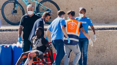 Migrant survivors disembark on the tiny Sicilian island of Lampedusa, Italy. AP