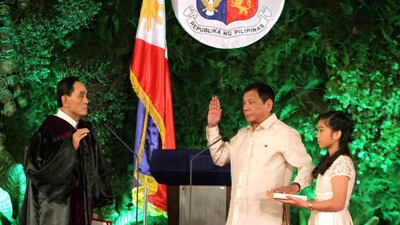 New Philippine President Rodrigo Duterte takes his oath as Philippines’ 16th president at Malacanang Palace in Manila. The News and Information Bureau, Malacanang Palace via AP