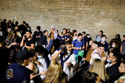 People celebrate on a street in the neighborhood of Born in Barcelona on the night the state of emergency was lifted in Spain, May 9, 2021. Reuters