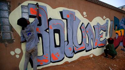 Sudanese revolutionaries paint murals along a wall in the Khartoum neighbourhood of Arkawit. AFP