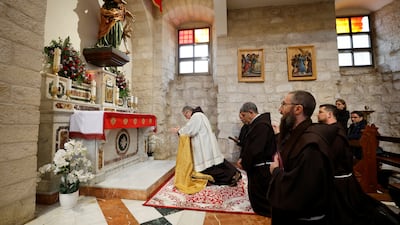 Father Francesco prays at the church. Reuters