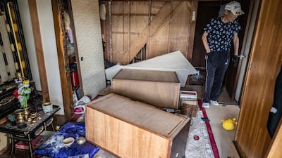 A resident of Kumamoto prefecture assesses the damage to his home after the earthquake, which killed at least 13 people. AFP