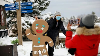 Guests take photos in the village of Blue Mountain Ski Resort in The Blue Mountains, Ontario, Canada. The Canadian Press via AP