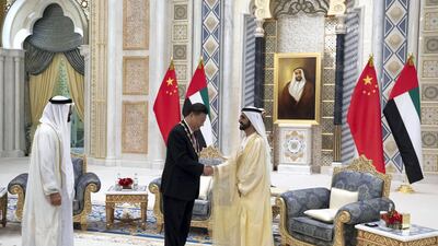 ABU DHABI, UNITED ARAB EMIRATES - July 20, 2018: HH Sheikh Mohamed bin Rashid Al Maktoum, Vice-President, Prime Minister of the UAE, Ruler of Dubai and Minister of Defence (R) and HH Sheikh Mohamed bin Zayed Al Nahyan, Crown Prince of Abu Dhabi and Deputy Supreme Commander of the UAE Armed Forces (L) present a Zayed Medal to HE Xi Jinping, President of China (C), during a reception at the Presidential Palace. ( Hamad Al Kaabi / Crown Prince Court - Abu Dhabi ) ---