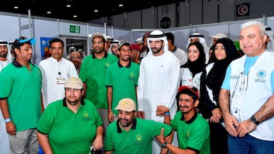 Sheikh Hamdan bin Mohammed poses for a photo with members of the Zayed Higher Organisation for Humanitarian Care at the Special Olympics Mena Games. Wam