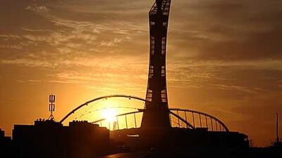 The sun sets over the Khalifa Stadium and neighbouring tower at Aspire Academy for Sports Excellence in Doha, Qatar.