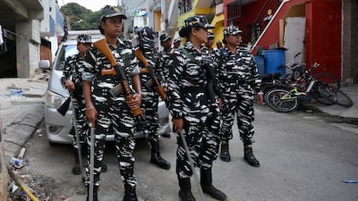 Central Reserve Police Force members stand guard in Bangalore, India on September 22 as the National Investigation Agency raids the offices of the Popular Front of India over terror-funding charges. EPA