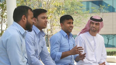 Campus physical development office manager Ibrahim al Hashimi, right, with staff members, from left, Mohammed Syed Ali, Mohammed Meraj and Iqbal Hussain Babul, talk about life and work at the faculty at Zayed University Campus in Abu Dhabi. Ravindranath K / The National