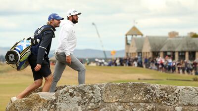 US golfer Cameron Young crosses the Swilcan Burn at the 18th hole on his way to an eight under par round of 64. EPA