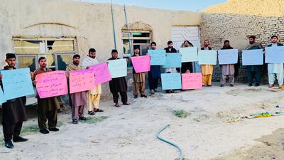 Pen Path volunteers hold placards calling for girls' right to education.