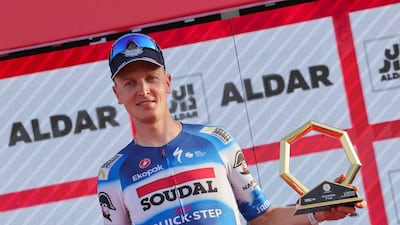 Soudal Quick–Step's Belgian rider Tim Merlier with the trophy after winning Stage 6 of the UAE Tour from the Louvre Abu Dhabi to Abu Dhabi Breakwater on February 24, 2024. AFP