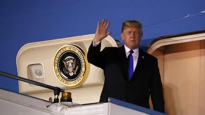 US President Donald Trump waves as he disembarks Air Force One after arriving in Singapore June 10, 2018. Jonathan Ernst / Reuters