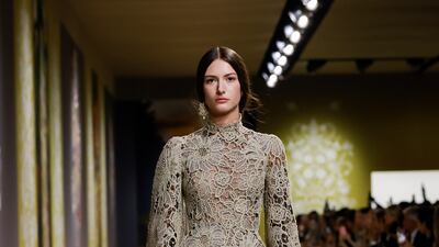 High-necked, floor-length gowns were sculpted from stiff embroidery.