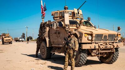 A US soldier stands by a US military armoured vehicle in the town of Tal Tamr along the M4 highway in the northeastern Syrian Hasakeh province, near the border with Turkey. AFP