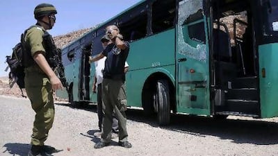 An Israeli soldier scans the aftermath of the bus ambush north of Eilat in the Sinai Thursday.