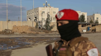 A Syrian government soldier stands outside SDF controlled Al Aktan prison, which holds ISIS detainees, as the Syrian amry takes possession of the nearby military base in Raqqa. AFP