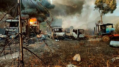 Smokes and flames billow from vehicles in Hpruso township, Kayah state, Myanmar on Saturday. Troops rounded up villagers, some believed to be women and children, fatally shot more than 30 and set the bodies on fire, a witness and other reports said. Photo: AP