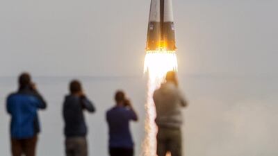 Photographers take pictures as the Soyuz TMA-18M spacecraft carrying the crew of Aidyn Aimbetov of Kazakhstan, Sergei Volkov of Russia and Andreas Mogensen of Denmark blasts off from the launch pad at the Baikonur cosmodrome, Kazakhstan / Reuters