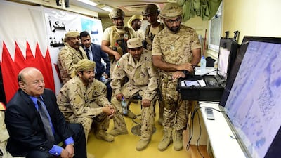 President Abdrabu Mansur Hadi joins UAE and Yemeni armed forces personnel at Al Anad airbase, which is being used to launch operations against the Houthis and to train Yemeni government fighters. EPA