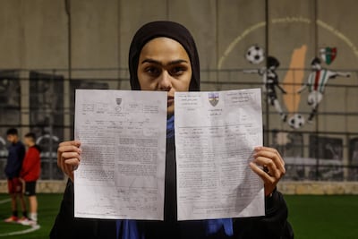 A Palestinian teenager holds up the demolition order issued by the Israeli army. Reuters